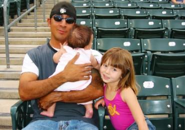 Father, Daughter, and Baby at Baseball Game