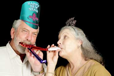 Couple Blowing Noisemakers on New Year's Eve
